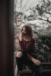woman sitting on wooden chair thumbnail