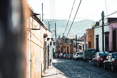 Cars parked along cobblestone way in the street thumbnail