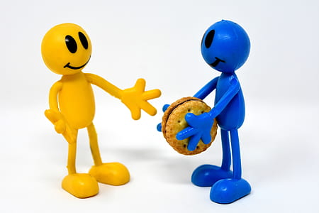 yellow and blue stick man holding biscuit figurines thumbnail