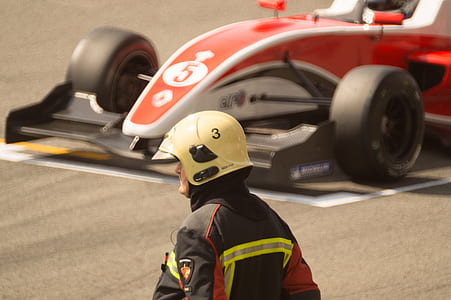 man in front of red race car thumbnail
