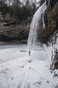 aerial view of person standing near waterfalls thumbnail
