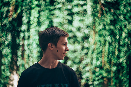 man wearing black crew-neck shirt looking left thumbnail