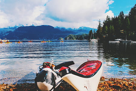 two canoes at the shore of the lake during day thumbnail