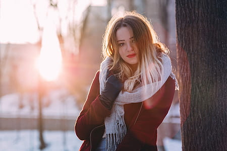 woman red long-sleeved jacket with white scarf near brown tree thumbnail