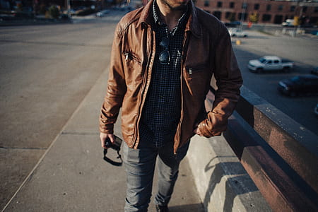 man standing beside brown handlebar thumbnail