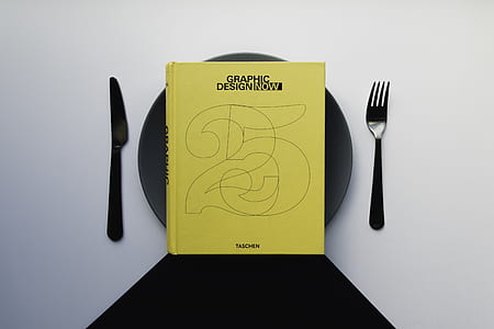 yellow book on black ceramic plate thumbnail