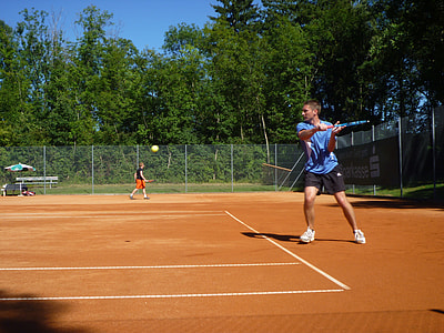 man playing tennis during daytime thumbnail