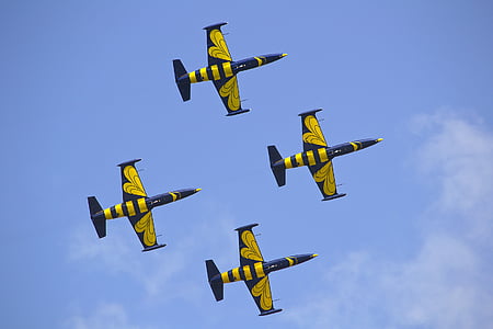 four black-and-yellow aircraft on sky thumbnail