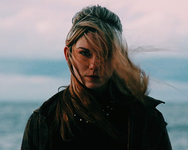 woman wearing brown coat thumbnail