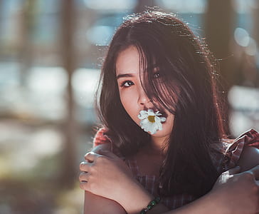 Close-up Photo of Woman in Brown Sleeveless Top With White Daisy Flower thumbnail