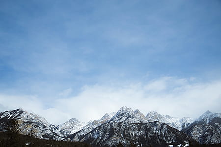 gray and black mountain range under blue sky thumbnail
