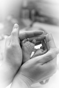 Hand Holding Feet of Baby thumbnail
