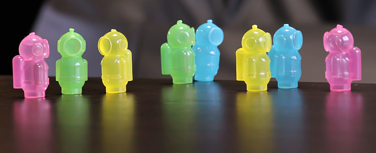 close-up photography of assorted-color plastic toys on wooden surface thumbnail
