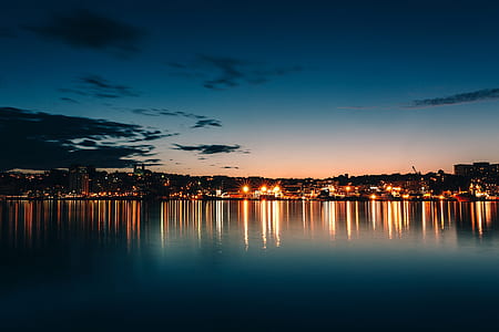 cityscape photography with clear skies and calm waters thumbnail