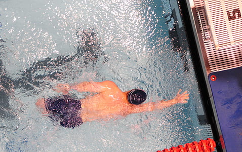 man swimming beneath pool thumbnail