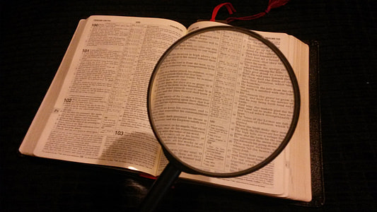 person holding magnifying glass thumbnail