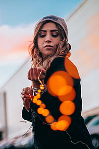 selective focus bokeh photography of woman pulling lights thumbnail