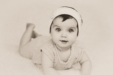 baby laying on white surface thumbnail