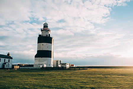 landscape photography of body of water with lighthouse thumbnail