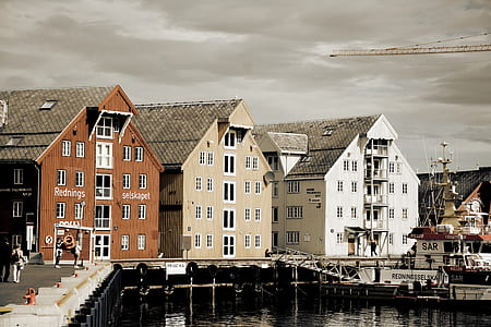 three brown, beige, and white buildings beside port thumbnail
