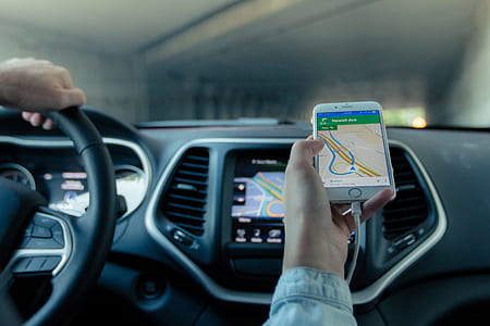 person holding gold iPhone 6 plus showing GPS navigation map thumbnail