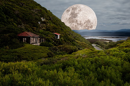 house on cliff and moon at distance during daytime thumbnail