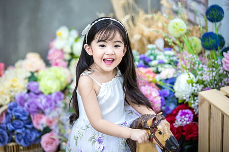 girl wearing white floral spaghetti strap dress thumbnail