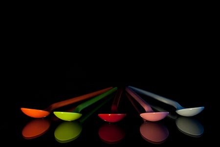 five assorted plastic spoons isolated with black background thumbnail