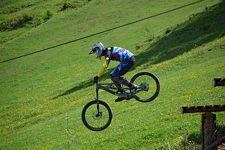 man riding mountain bike doing tricks during daytime thumbnail