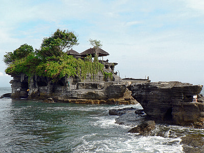 brown cottage on cliff surrounded with water thumbnail