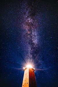 brown lighthouse under midnight thumbnail