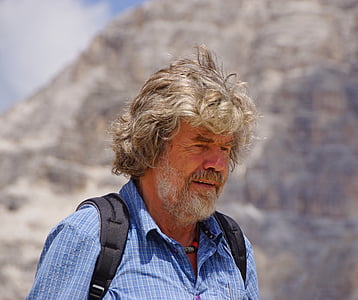 man wearing blue shirt and black backpack thumbnail