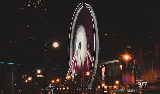 white ferris wheel near building thumbnail