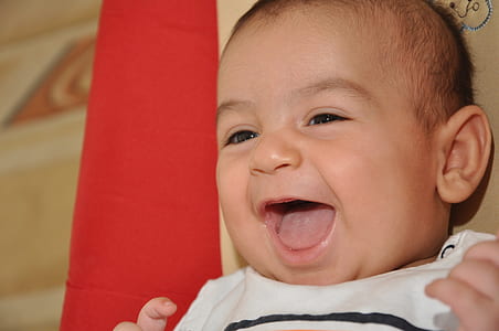 close up photo of laughing baby thumbnail