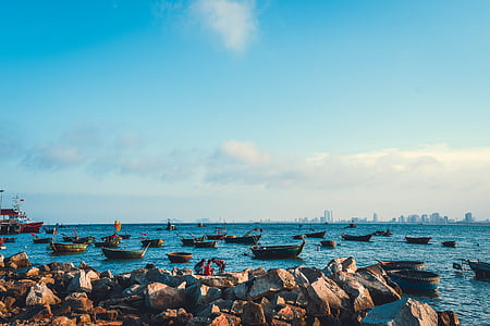 boats on water under blue and white sky thumbnail