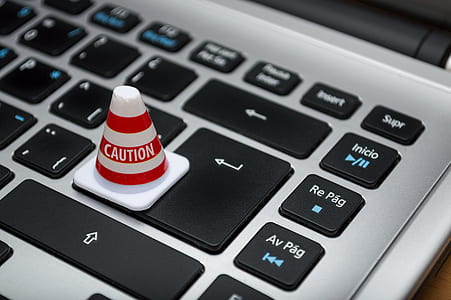 traffic cone miniature on laptop keyboard keys thumbnail