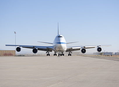 white passenger plane on gray open field at daytime thumbnail