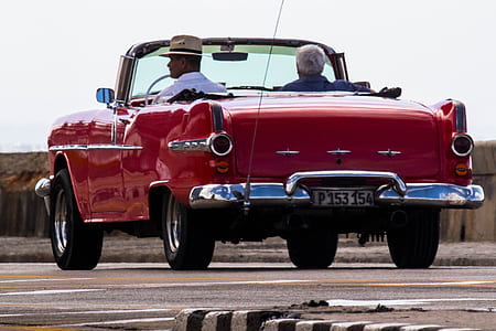classic red convertible on roadwayh thumbnail