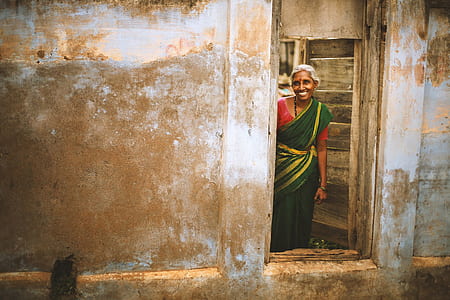 woman wearing green dress standing near door thumbnail