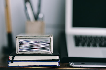 Elegant workspace with Macbook, iPhone, business cards and notebooks thumbnail