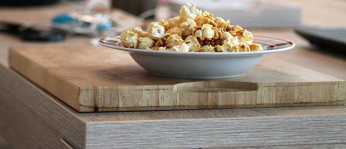 bowl of popcorn on brown wooden board thumbnail