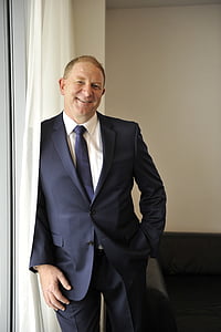 man wearing black suit jacket and dress pants with necktie and dress shirt thumbnail