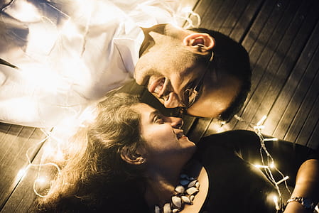 man wearing white button-up collared top and woman wearing black scoop-neck elbow-sleeved top thumbnail