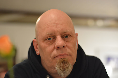 man in black pullover hoodie in close-up photo thumbnail