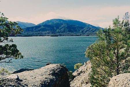 landscape photography of mountain and body of water thumbnail