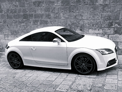 white Audi TT parked beside wall thumbnail
