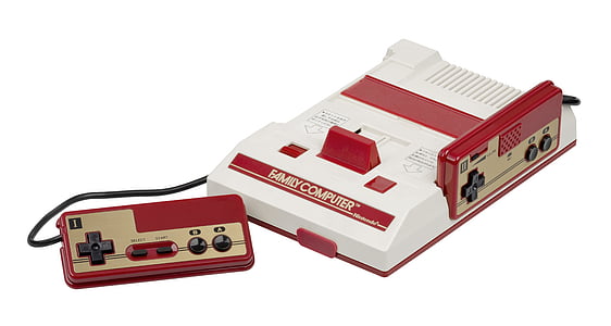 white and red Family Computer console and two gamepads thumbnail