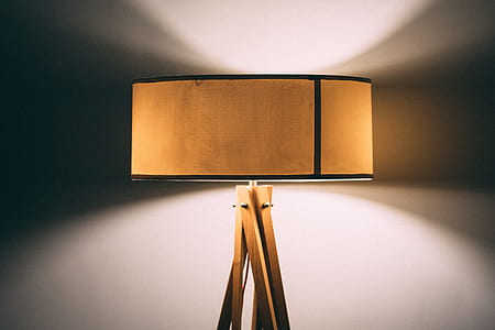 brown and black tripod floor lamp behind the wall thumbnail