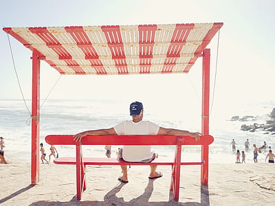 man sitting on bench spreading his arms thumbnail