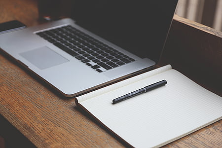 black pen on graphing paper beside Macbook Pro thumbnail